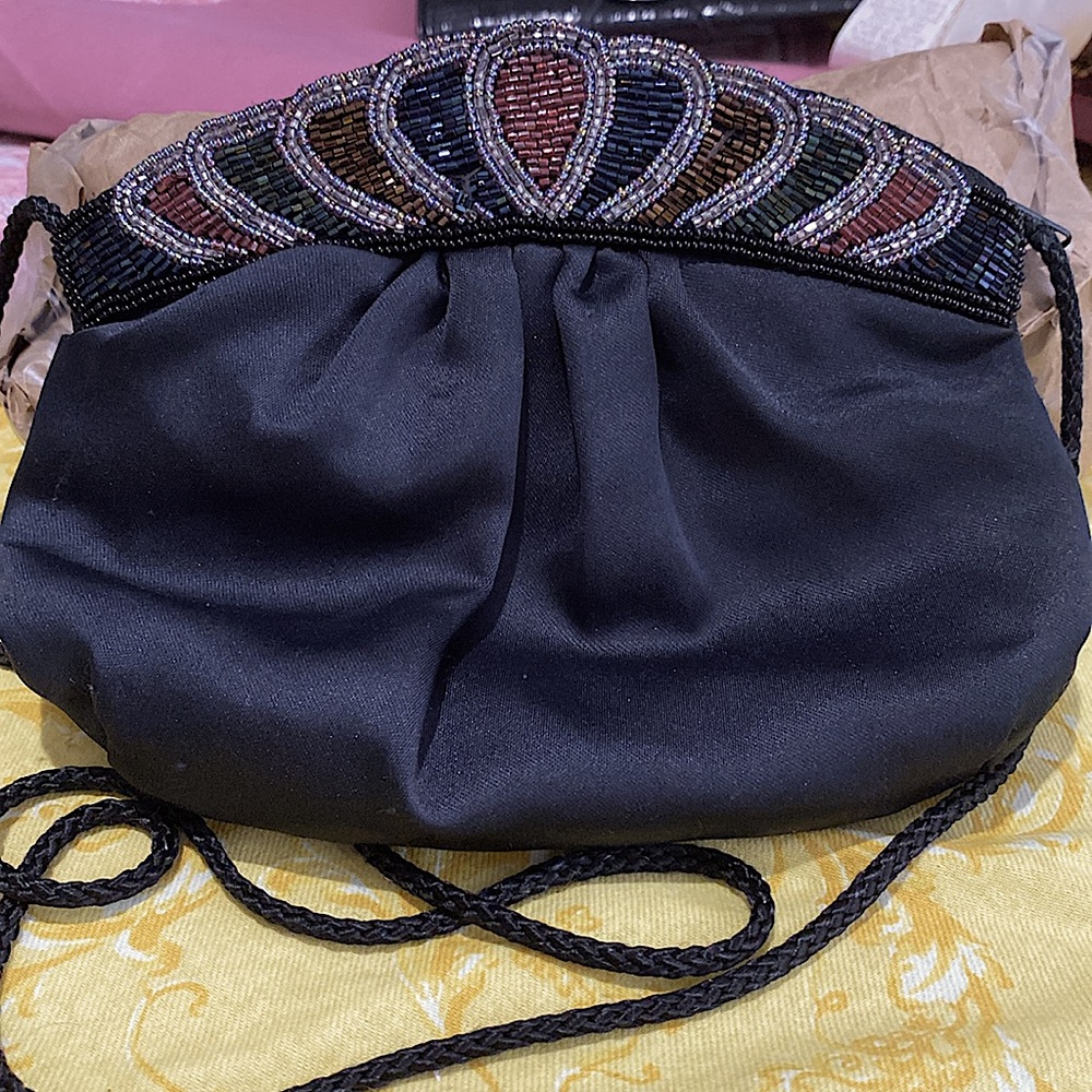 Black satin like evening bag with embellishment (beads) in front. Rope strap.EUC